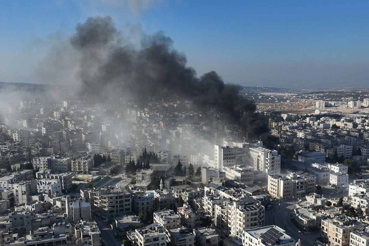 An aerial picture shows smoke rising from the site of an airstrike that targeted Syria's rebel-held northern city of Idlib on December 2.