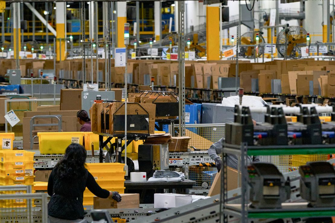 Workers prepare packages for shipping at a Robbinsville, New Jersey, Amazon facility on Cyber Monday of 2024.