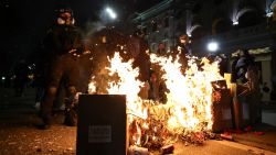 Protesters stand at burning cardboard boxes during the fifth straight night of demonstrations against the government's postponement of EU accession talks until 2028, in central Tbilisi on December 2, 2024. (Photo by Giorgi ARJEVANIDZE / AFP) (Photo by GIORGI ARJEVANIDZE/AFP via Getty Images)