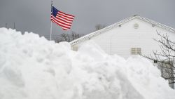 ERIE, PENNSYLVANIA - DECEMBER 2:The flag flies over the Lawrence Athletic Club in front of a mountain of snow after a record snowfall left over 3 feet on the ground on December 2, 2024 in Erie, Pennsylvania. As of Monday morning, some parts of Erie County, Pennsylvania had received up to 60 inches of snow according to unofficial reports from the National Weather Service prompting the Mayor of the City of Erie to declare a weather emergency. (Photo by Jeff Swensen/Getty Images)