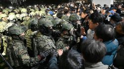 Soldiers try to enter the National Assembly building in Seoul on December 4 2024, after South Korea President Yoon Suk Yeol declared martial law. South Korea's President Yoon Suk Yeol on December 3 declared martial law, accusing the opposition of being "anti-state forces" and saying he was acting to protect the country from "threats" posed by the North.