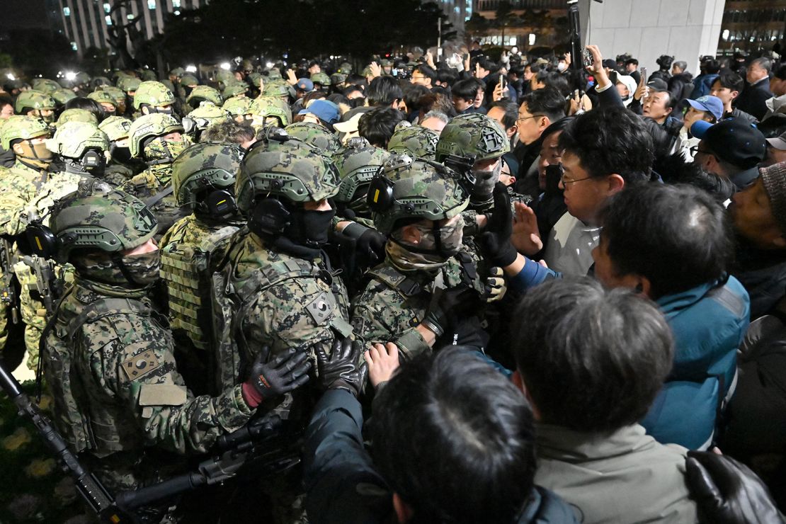 Soldiers try to enter the National Assembly building in Seoul on December 4 2024, after South Korea President Yoon Suk Yeol declared martial law.