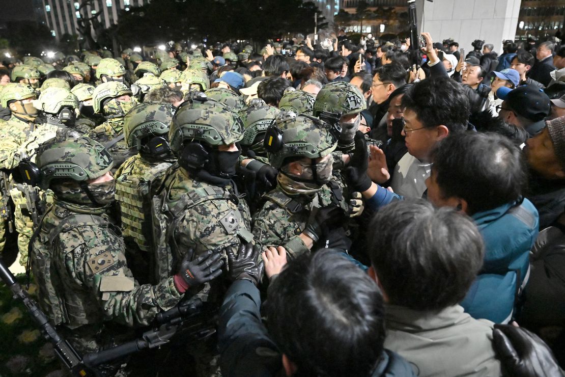 Soldiers try to enter the legislature in Seoul after the martial law decree on December 4, 2024.