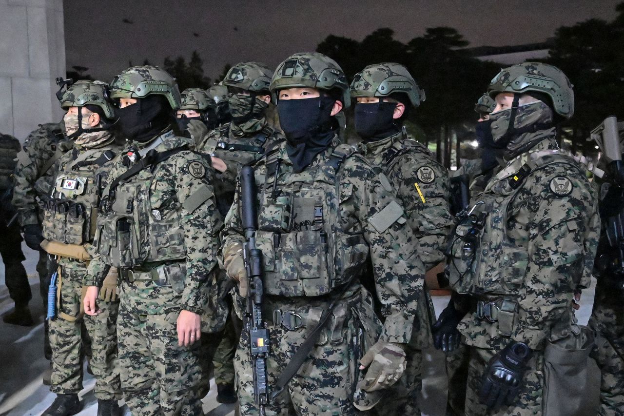 Soldiers try to enter the National Assembly building in Seoul on December 4 2024, after South Korea President Yoon Suk Yeol declared martial law.