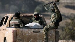 TOPSHOT - Anti government fighters ride in the back of a pick truck in the town of Suran, between Aleppo and Hama, on December 3, 2024. Islamist-led rebels advanced on December 3, on Syria's fourth-largest city Hama, buoyed by their lightning capture of swathes of the north in an offensive that ended four years of relative calm. Syrian state media reported that the two air forces had bombed the rebels in their Idlib stronghold as well as their vanguard in Hama province (Photo by Bakr ALKASEM / AFP) (Photo by BAKR ALKASEM/AFP via Getty Images)