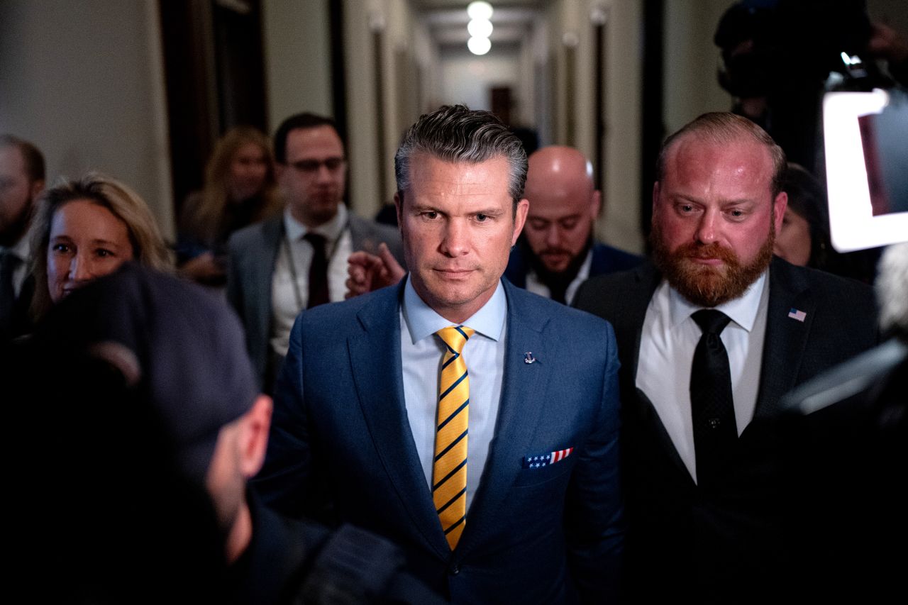 President-elect Donald Trump's nominee to be Secretary of Defense Pete Hegseth, center, walks through the Russell Senate Office Building on Capitol Hill on Tuesday, December 3.