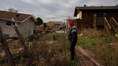 NORTH SIOUX CITY, SD - NOV. 24: Morgan Speichinger walks through the backyards of her neighbors' destroyed homes five months after a June 23 flood near McCook Lake in North Sioux City, South Dakota, on Sunday, Nov. 24, 2024. (Photo by Rebecca S. Gratz for The Washington Post via Getty Images)