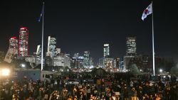 People gather for a protest against South Korea President Yoon Suk Yeol on the grounds of the National Assembly in Seoul on December 4, 2024. Thousands marched on parliament in South Korea's capital on December 4, joining a bid by the country's opposition to impeach President Yoon Suk Yeol after his extraordinary but short-lived imposition of martial law. (Photo by Anthony WALLACE / AFP) (Photo by ANTHONY WALLACE/AFP via Getty Images)