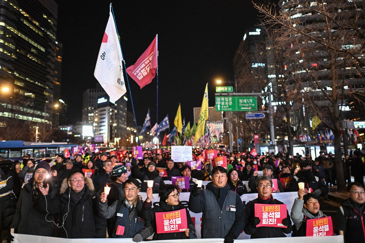 Protesters take part in a march against South Korea President Yoon Suk Yeol as they head toward the National Assembly in Seoul on December 4.