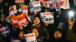 TOPSHOT - People take part in a protest calling for the resignation of South Korea President Yoon Suk Yeol at the National Assembly in Seoul on December 4, 2024. Thousands marched on parliament in South Korea's capital on December 4, joining a bid by the country's opposition to impeach President Yoon Suk Yeol after his extraordinary but short-lived imposition of martial law. (Photo by Anthony WALLACE / AFP) (Photo by ANTHONY WALLACE/AFP via Getty Images)