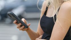 NEWCASTLE, AUSTRALIA - DECEMBER 01: A woman uses her smartphone on December 01, 2024 in Newcastle, Australia. Australia has recently enacted a groundbreaking law prohibiting individuals under the age of 16 from accessing social media platforms, marking one of the strictest regulations of its kind globally. This legislation, which holds social media companies accountable for enforcing the ban with potential fines of up to AUD 50 million, aims to protect young users from online dangers such as bullying and exploitation, reflecting a significant shift in how governments address youth safety in the digital age. (Photo by Roni Bintang/Getty Images)