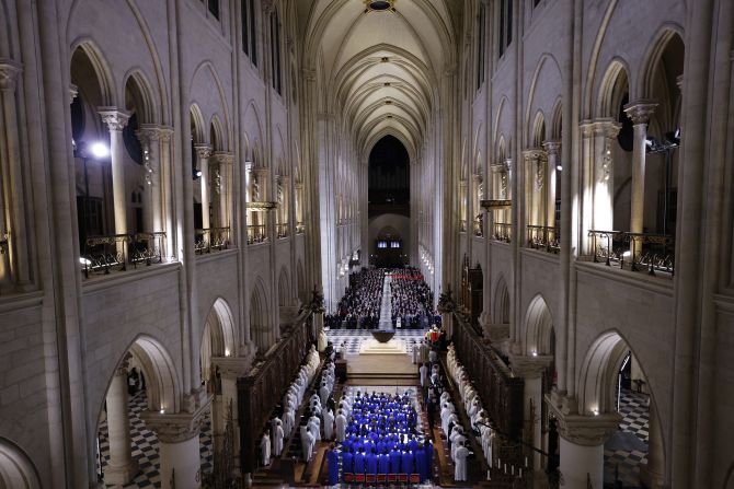 The choir, clergy and congregation stand to sing during the grand reopening ceremony.