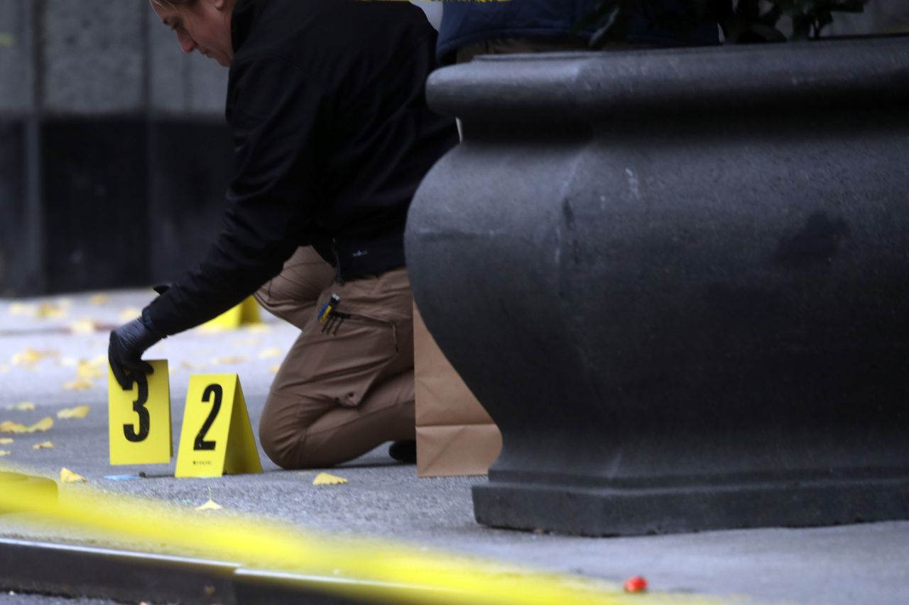 Police place bullet casing markers outside of a Hilton Hotel in New York, where UnitedHealthcare CEO Brian Thompson was fatally shot on December 4.