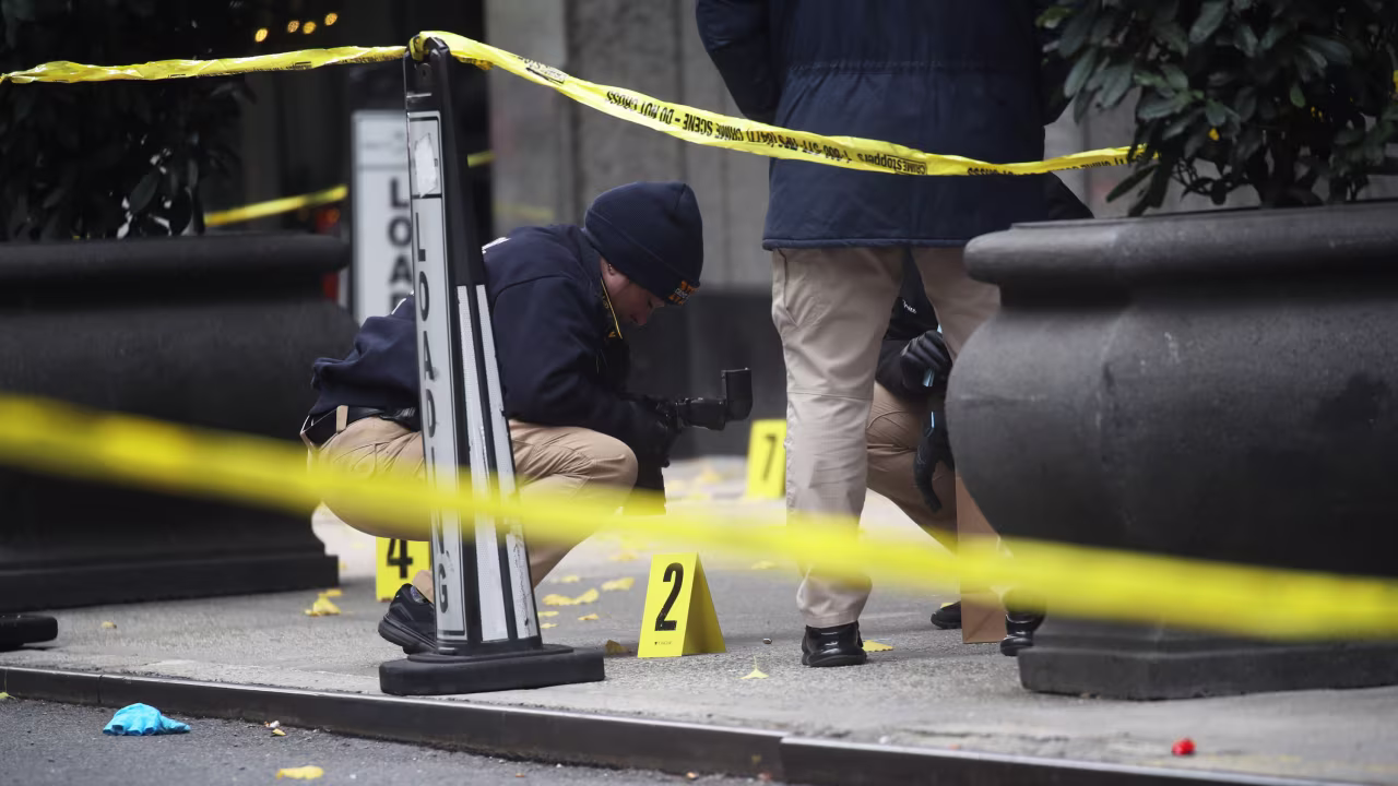 Police place bullet casing markers outside of a Hilton Hotel in New York, where United Healthcare CEO Brian Thompson was fatally shot, on December 4.