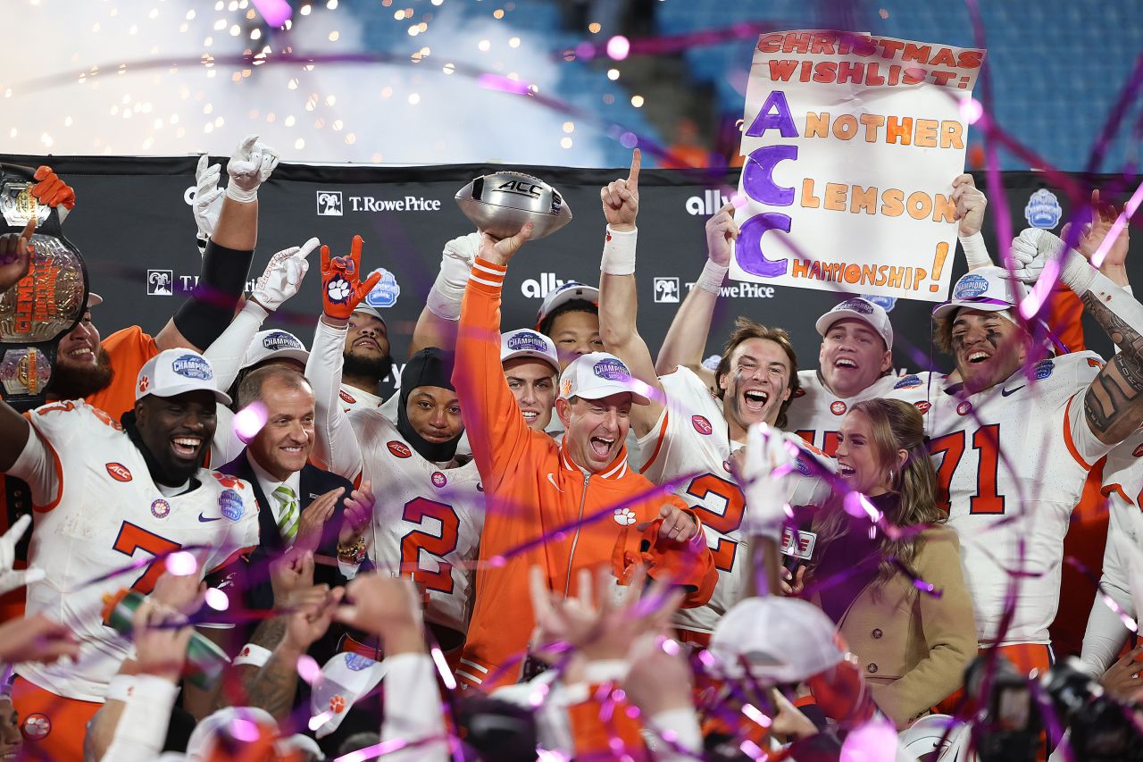 Clemson Tigers head coach Dabo Swinney holds the ACC championship trophy after defeating the SMU Mustangs in Charlotte, North Carolina, on December 7.