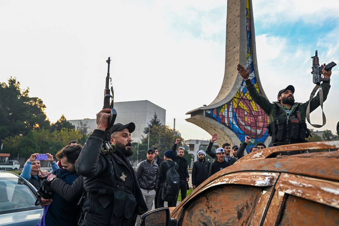 anti-government fighters celebrate at umayyad square in damascus on december 8, 2024.