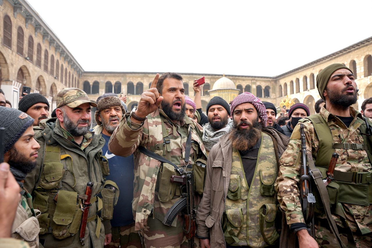 Fighters celebrate in Damascus' Omeyyad mosque on December 8, 2024, after Islamist-led rebels declared that they have taken the Syrian capital in a lightning offensive.