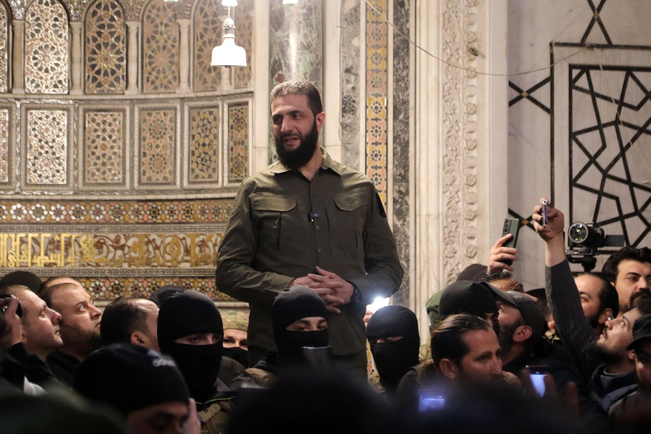 Abu Mohammed al-Jolani addresses a crowd at Umayyad Mosque in Damascus on December 8.