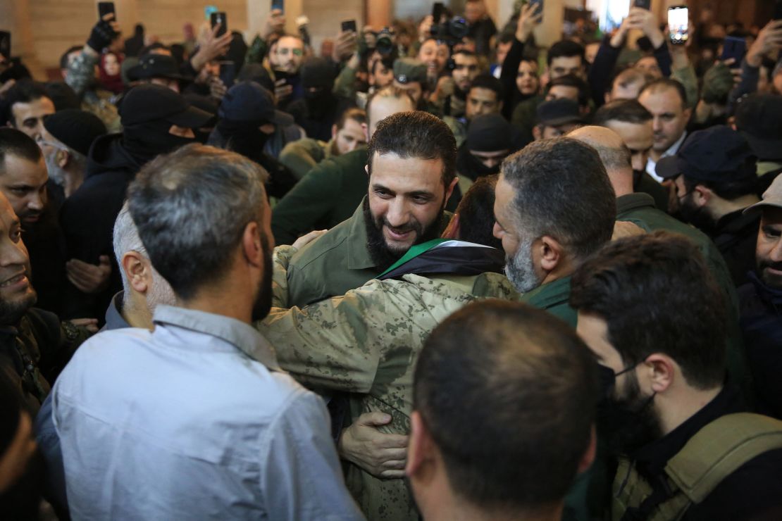 People welcome the leader of Syria's Islamist Hayat Tahrir al-Sham (HTS) group, Abu Mohammed al-Jolani, before his speech at the Umayyad Mosque on December 8, 2024.