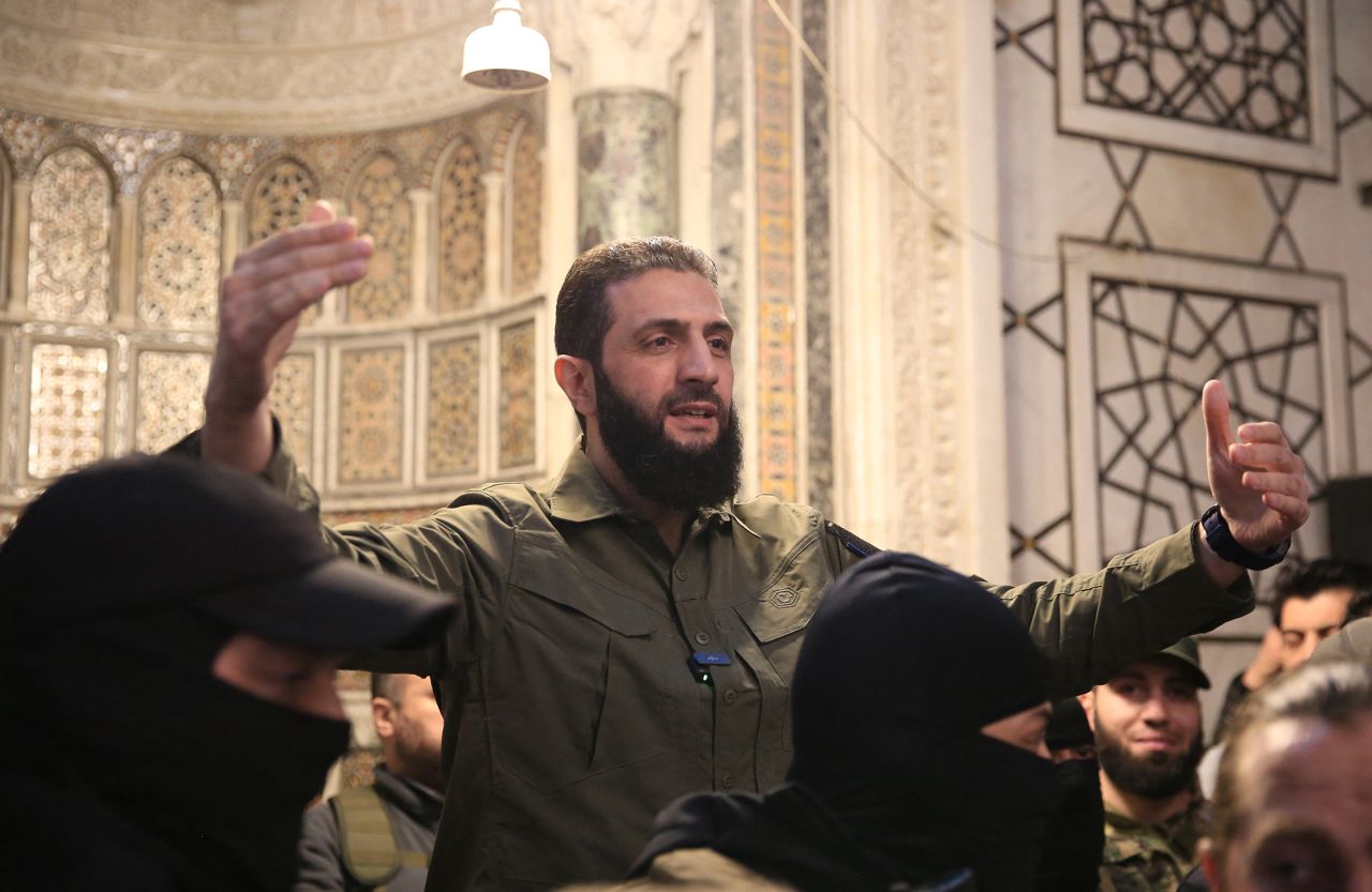 The leader of Syria's Islamist Hayat Tahrir al-Sham (HTS) group, Abu Mohammad al-Jolani, address a crowd at the capital's landmark Umayyad Mosque on December 8.