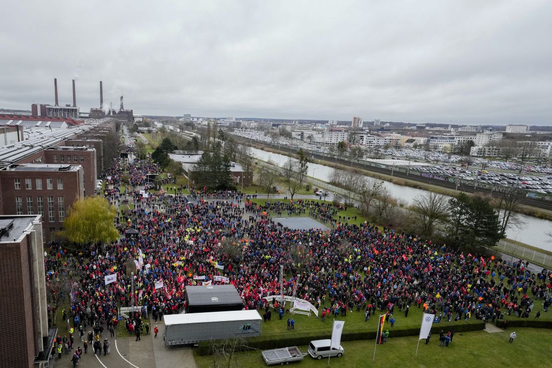 Employees attend a metalworkers' union rally in front of automaker Volkswagen's headquarters during a warning strike at its main factory in Wolfsburg, northern Germany, on December 9.