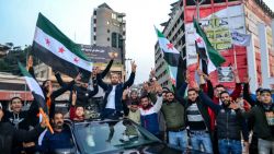 Syrian and Lebanese people in the northern Lebanese city of Tripoli celebrate on December 9, 2024, after Islamist-led rebels declared that they have taken the Syrian capital in a lightning offensive, sending President Bashar al-Assad fleeing and ending five decades of Baath rule in Syria. (Photo by Fathi AL-MASRI / AFP) (Photo by FATHI AL-MASRI/AFP via Getty Images)