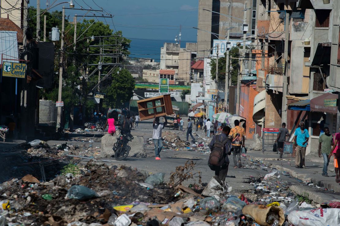 Residents evacuate Poste Marchands in Port-au-Prince, Haiti, on December 9, 2024, after gangs took control of the region. Laveus says it's terrifying to think what could happen if her brother and nephew are sent back to Haiti, where violence continues to intensify.