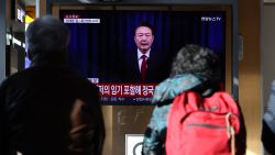 SEOUL, SOUTH KOREA - DECEMBER 07: A screens shows footage of South Korean President Yoon Suk Yeol delivering an address to the nation at Seoul station on December 07, 2024 in Seoul, South Korea. South Korea is facing significant political turmoil after President Yoon Suk-yeol declared emergency martial law, accusing opposition parties of destabilizing governance and sympathizing with North Korea. His controversial move, since rescinded after a 190-0 vote by lawmakers condemning the move, has sparked widespread criticism, calls for Yoon's resignation, and raised concerns about the implications for democracy in the country. (Photo by Chung Sung-Jun/Getty Images)