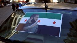 The portrait of Islamist group Hayat Tahrir al-Sham (HTS) leader Abu Mohammed al-Jolani is pictured on the back of a car in the coastal Syrian city of Latakia, on December 10, 2024. Islamist-led rebels declared on December 8, that they have taken the Syrian capital in a lightning offensive, sending President Bashar al-Assad fleeing and ending five decades of Baath rule in Syria. The region of Latakia was the heartland of Assad's minority Alawite community, but after the rebel takeover, people there toppled a statue of the deposed dictator's father. (Photo by AAREF WATAD / AFP) (Photo by AAREF WATAD/AFP via Getty Images)