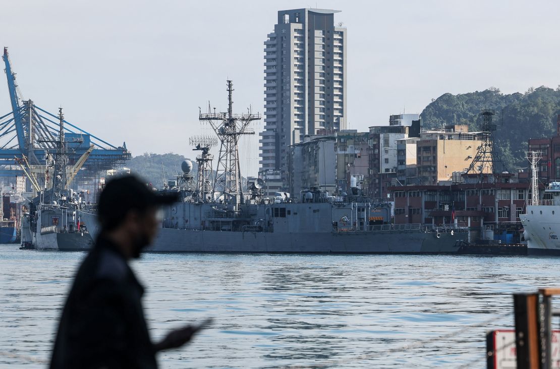 A man stands before Taiwanese Navy ships anchored at the harbor in Keelung, Taiwan, on December 11, 2024.