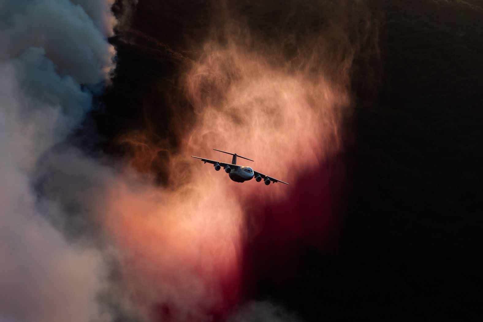 An airplane drops fire retardant on the Franklin Fire on Tuesday.