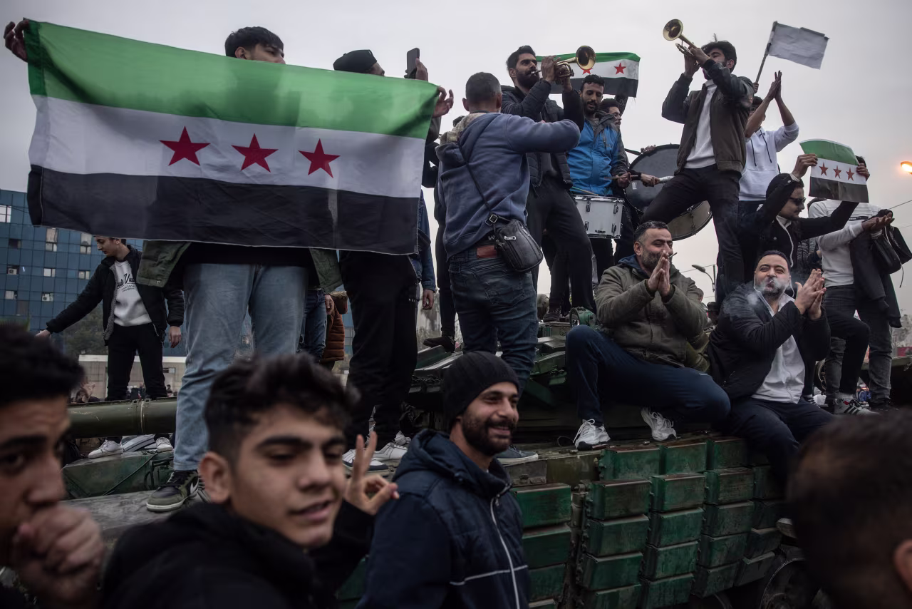 Musicians play on top of a destroyed tank in Umayyad Square in Damascus, Syria, on December 11.