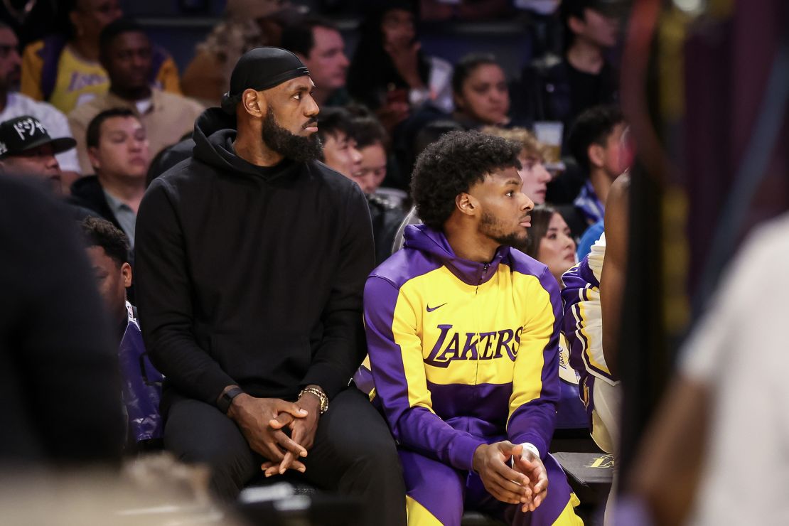 LeBron James and his son Bronny watch from the bench during the first half of the Lakers' game against the Portland Trail Blazers at Crypto.com Arena on Dec. 8.