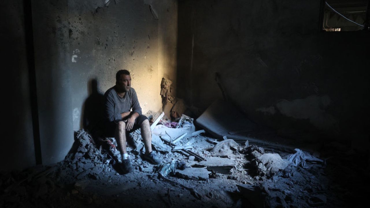 EDITORS NOTE: Graphic content / A Palestinian man sits inside a destroyed building in the Nuseirat refugee in the central Gaza Strip on December 13, 2024, amid the continuing war between Israel and Hamas. (Photo by Eyad BABA / AFP) (Photo by EYAD BABA/AFP via Getty Images)