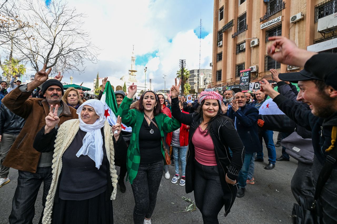 People celebrate the collapse of Bashar al-Assad's rule while gathering on a street in Sweida, Syria, on December 13,.