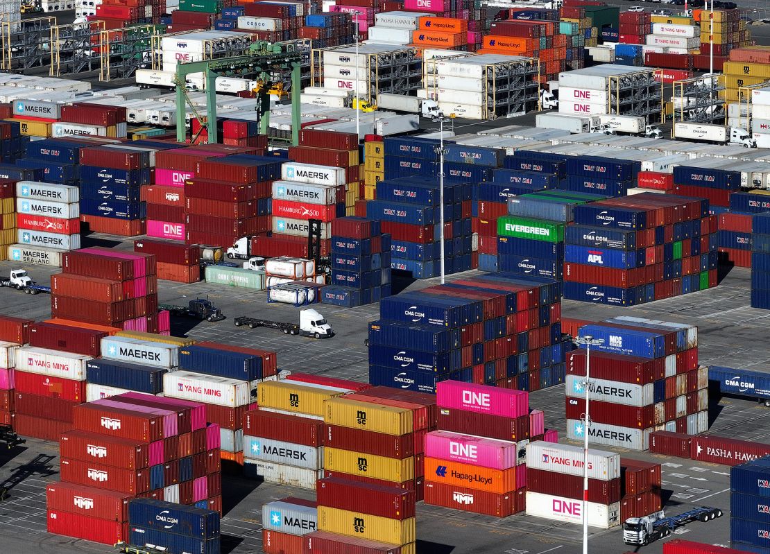 In an aerial view, shipping containers are stacked on a dock at the Port of Oakland on December 09, 2024 in Oakland, California. U.S. President-elect Donald Trump is threatening new tariffs on multiple countries as his second term approaches, after making tariffs a signature of his 2024 presidential campaign.