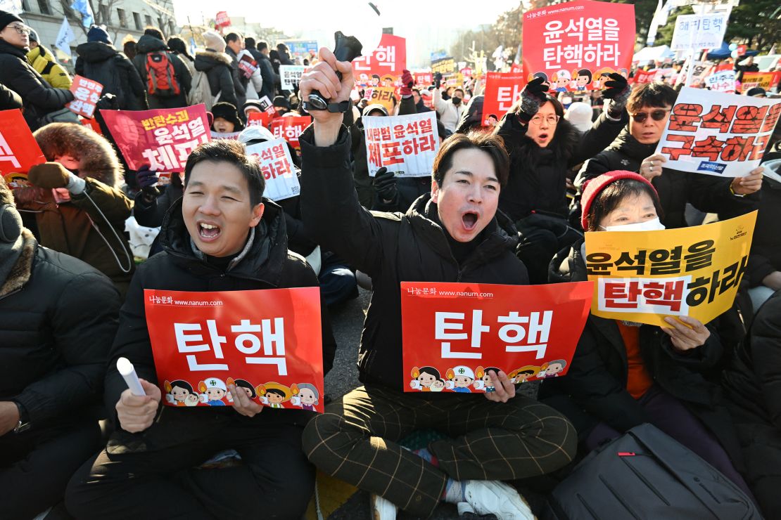 People shout slogans calling for Yoon's impeachment outside the National Assembly in Seoul on December 14.