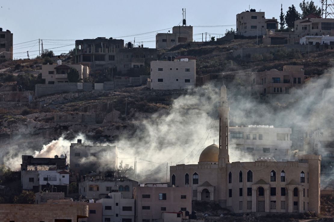 Smoke rises following an explosion amid clashes between Palestinian Authority security forces and militants in Jenin.