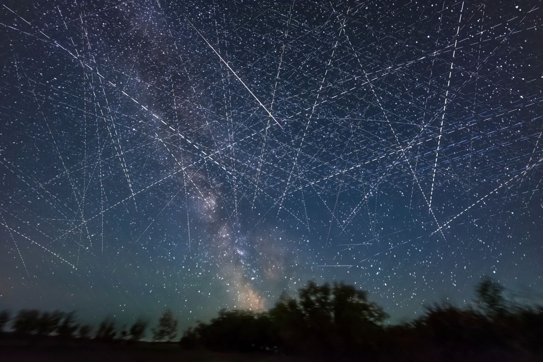 Adding together exposures taken over 30 minutes on an early June night, a composite image depicts the satellite-filled sky.