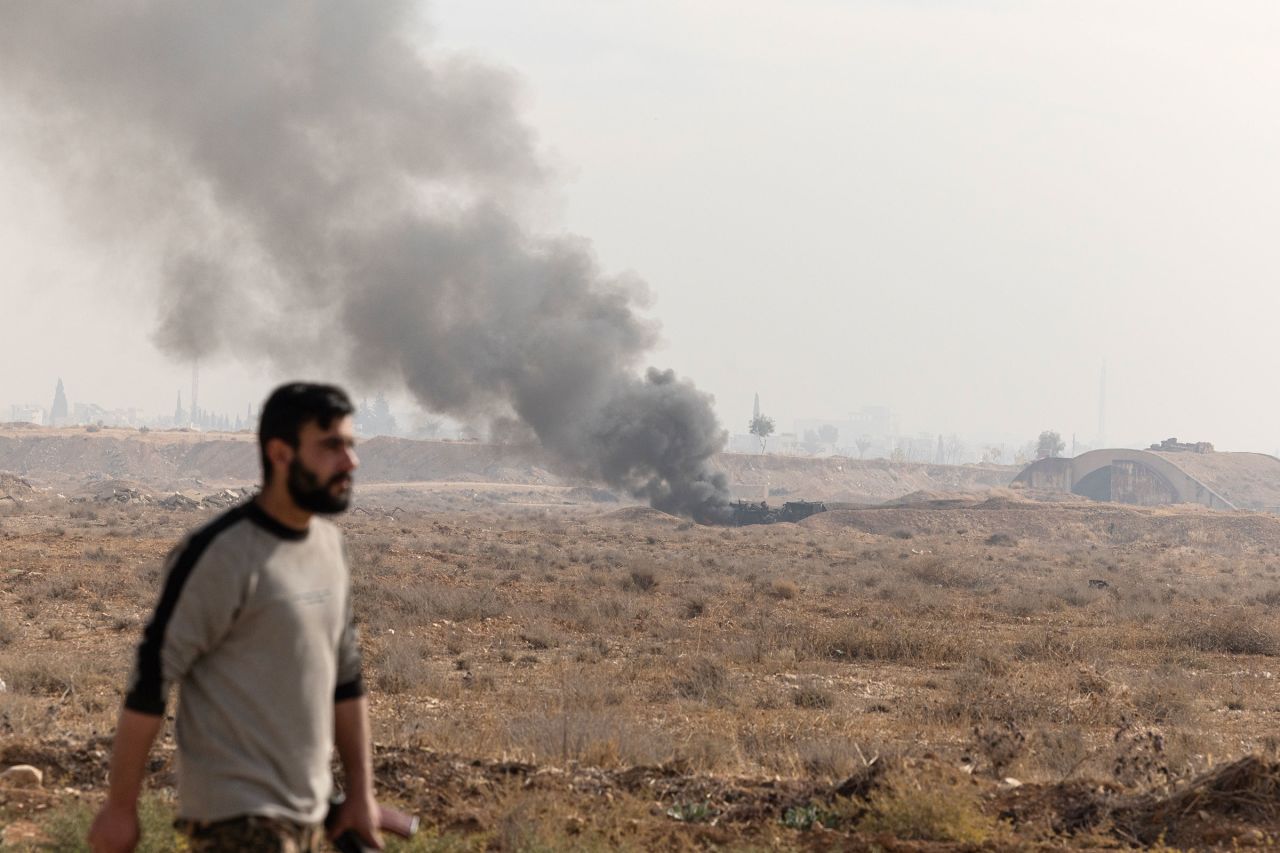 Smoke billows into the air following an Israeli drone strike on Al Mazzeh Airport in Damascus, Syria, on December 11.