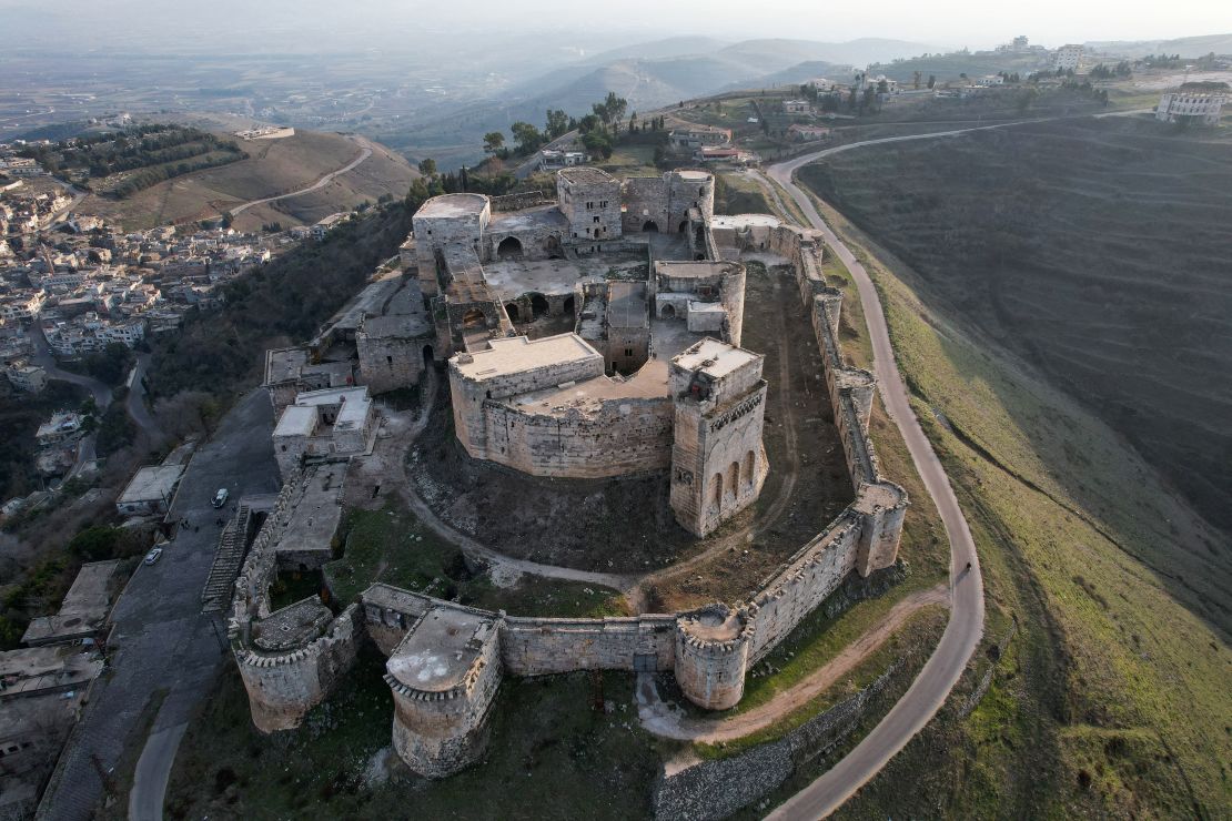 An aerial picture shows a view of the strategic medieval fortress Krak des Chevaliers in Syria's Homs province on December 15, 2024. The UNESCO-listed fortress, also known as al-Hosn, sits atop a high ridge since the early 11th century in what is now the Homs province of modern-day Syria, and has seen as many expansions and fortifications as the rulers fighting for control of its strategic location. Many centuries later, after civil war broke out in Syria in 2011, the fortress again became a battleground, this time between government forces and rebels. (Photo by Aaref WATAD / AFP) (Photo by AAREF WATAD/AFP via Getty Images)