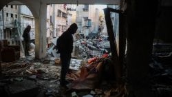 People search through the debris of a house that was destroyed in an Israeli strike the day before, which killed Al Jazeera journalist Ahmad Baker Al-Louh along with members of the Civil Defence, in Nuseirat on December 16, 2024. Qatar-based Al Jazeera condemned the December 15 killing of one of its journalists in an Israeli strike on Gaza, calling the death a "targeted killing" in a statement. (Photo by Eyad BABA / AFP) (Photo by EYAD BABA/AFP via Getty Images)