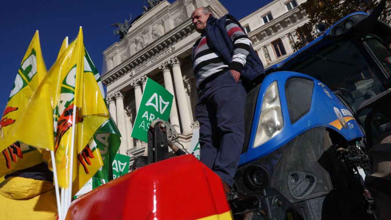 A farmer stands on a tractor outside the Agriculture Ministry during a demonstration organized by various agricultural organisations to oppose the EU-Mercosur free trade deal and demand a reform of the Common Agricultural Policy (PAC) in Madrid on December 16, 2024. (Photo by Pierre-Philippe MARCOU / AFP) (Photo by PIERRE-PHILIPPE MARCOU/AFP via Getty Images)