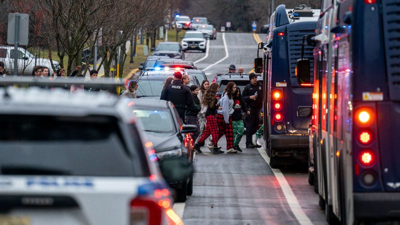 A second-grader was the first to call 911 as another student opened fire at her Wisconsin school, killing 2 and injuring 6