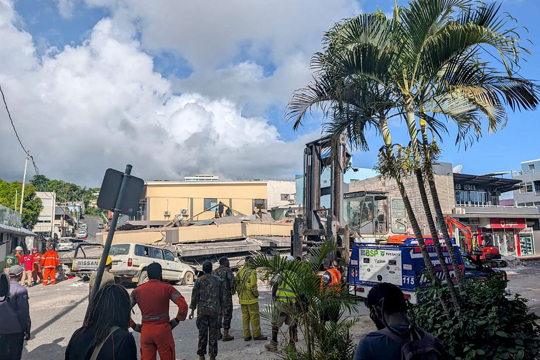 Rescue workers are seen at the site of a collapsed building after a powerful earthquake struck Port Vila, the capital of Vanuatu, on December 17, 2024.