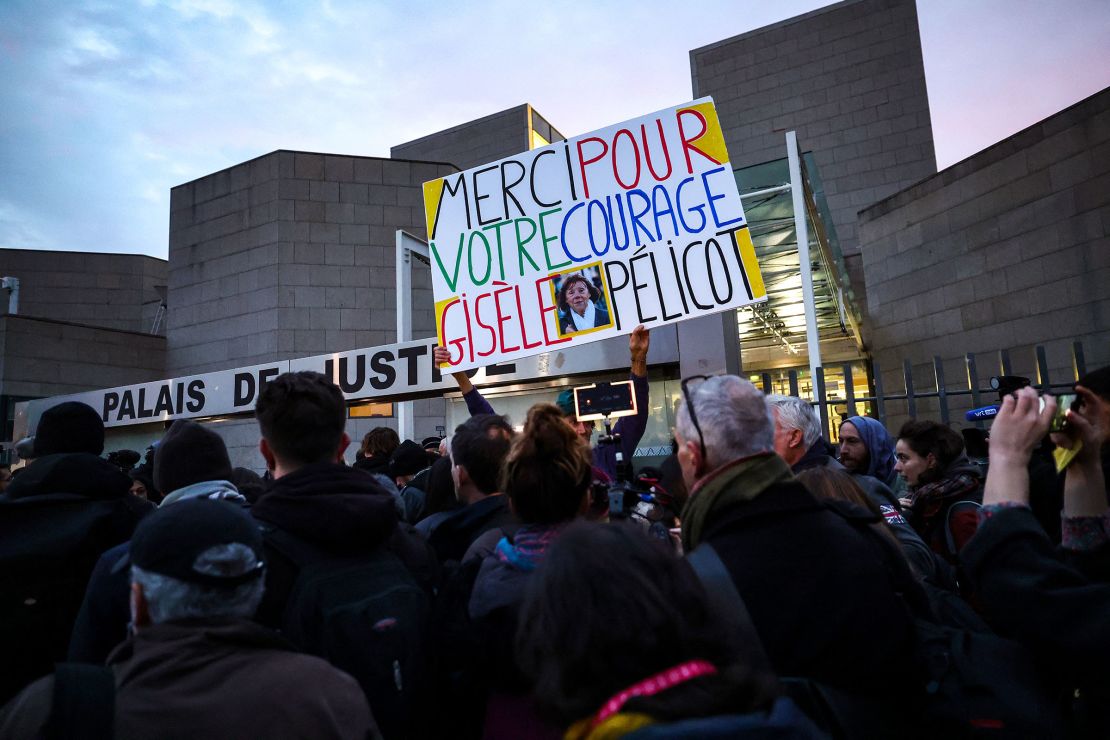 French artist and activist Voltuan holds a sign that reads in French: "Thank you for your courage Gisele Pelicot," outside the Avignon courtroom on Thursday.