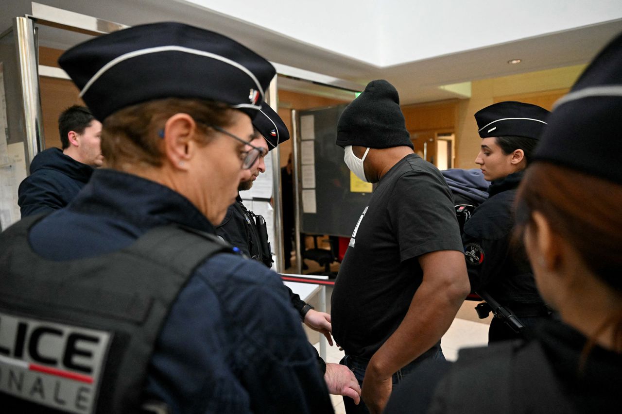 One of the defendant arrives at the courthouse in Avignon on December 19.