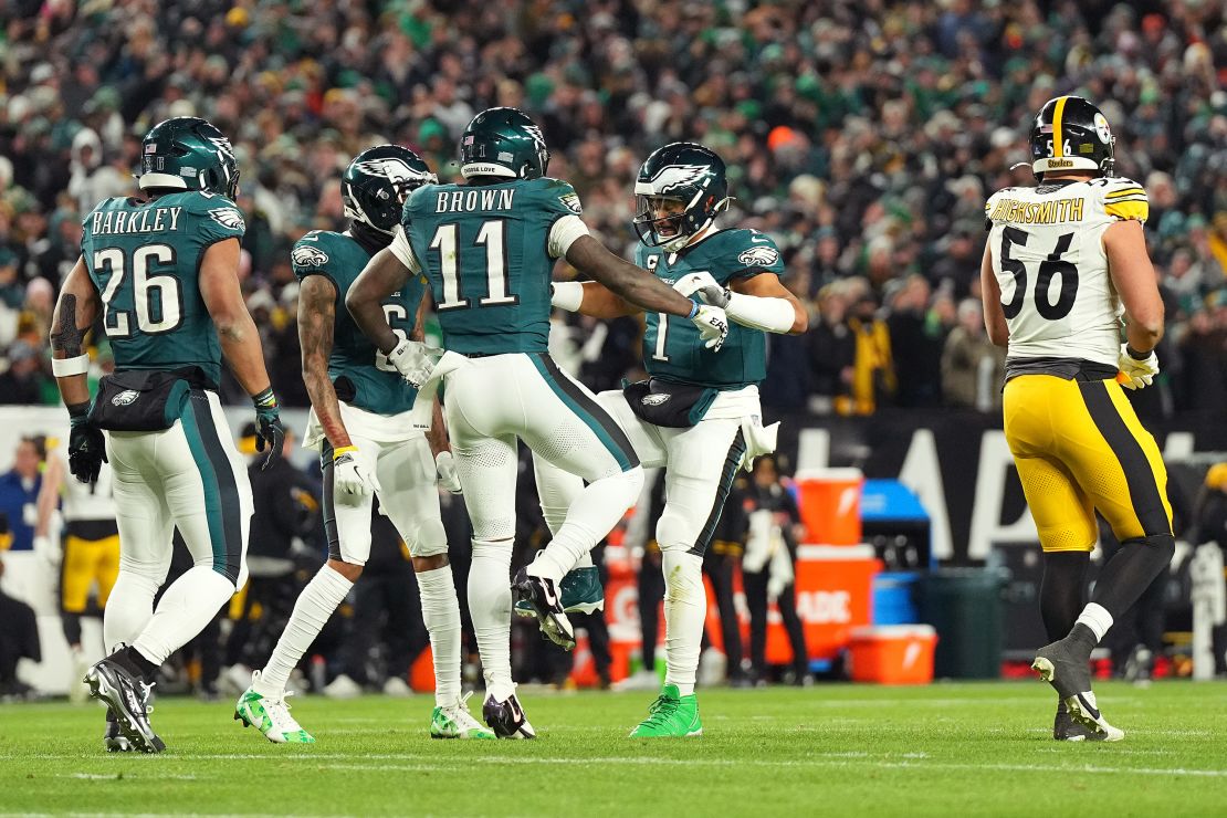 PHILADELPHIA, PENNSYLVANIA - DECEMBER 15: A.J. Brown #11 of the Philadelphia Eagles celebrates with teammate Jalen Hurts #1 after scoring a touchdown against the Pittsburgh Steelers during the first quarter at Lincoln Financial Field on December 15, 2024 in Philadelphia, Pennsylvania. (Photo by Mitchell Leff/Getty Images)