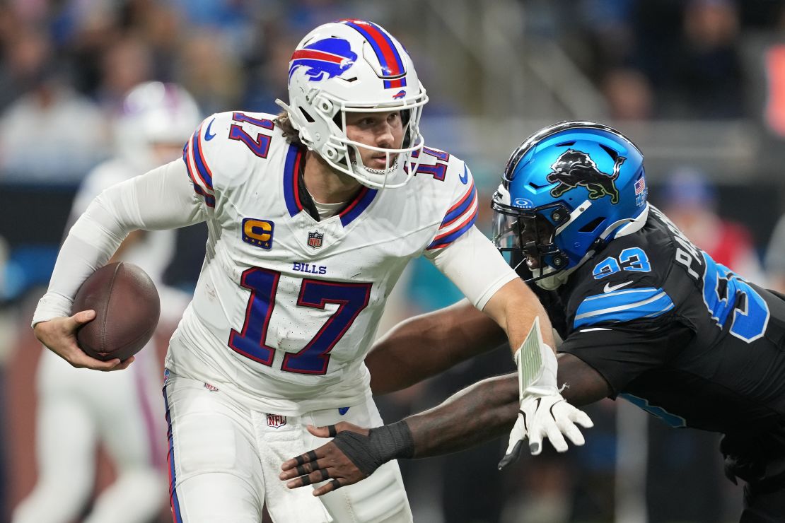 DETROIT, MICHIGAN – DECEMBER 15: Josh Allen #17 of the Buffalo Bills runs with the ball while being chased by Josh Paschal #93 of the Detroit Lions in the third quarter at Ford Field on December 15, 2024 in Detroit, Michigan. (Photo by Nic Antaya/Getty Images)