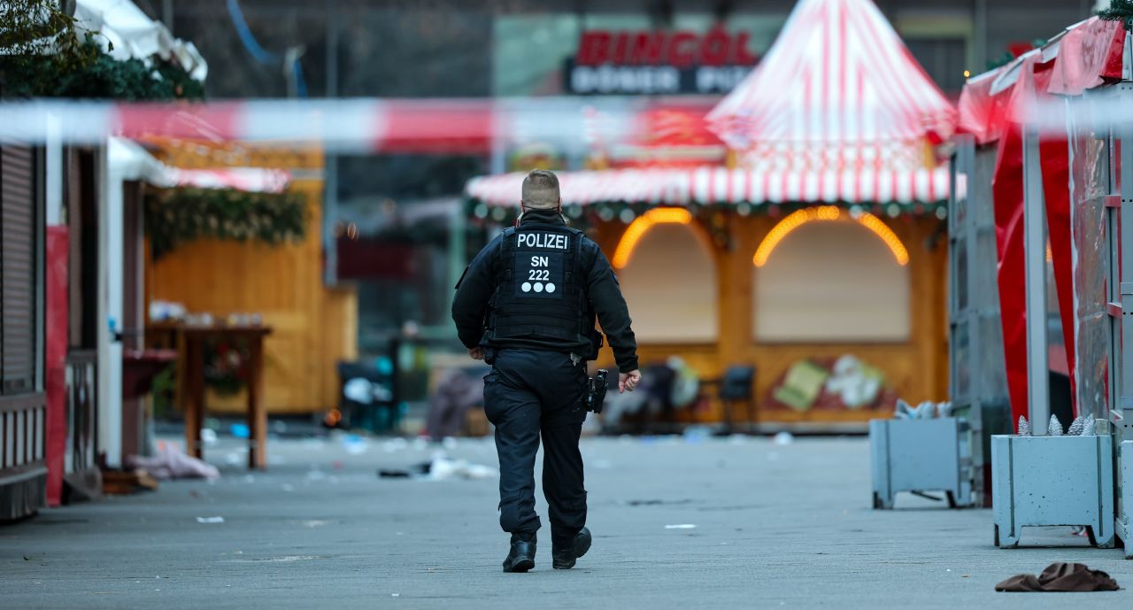 A police officer walks behind a barrier at the Magdeburg Christmas market on Saturday.